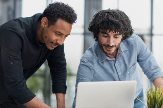 Business professionals collaborating happily in a modern office with technology.