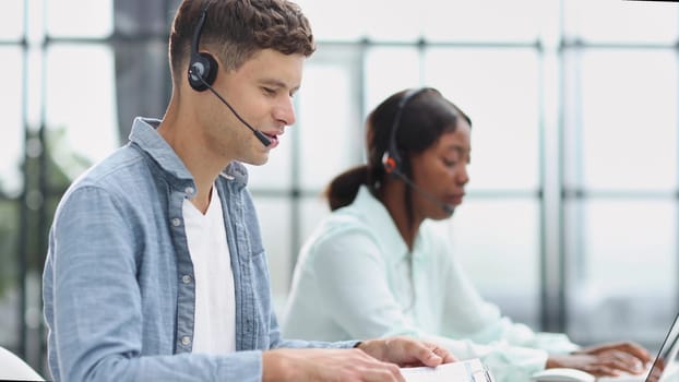 operators woman and man agent with headsets working in a call center.