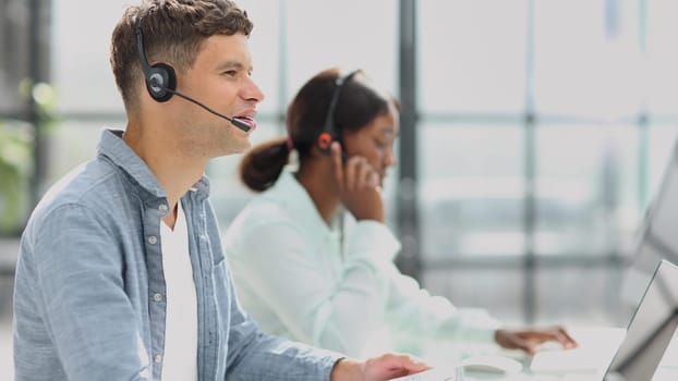 operators woman and man agent with headsets working in a call center.