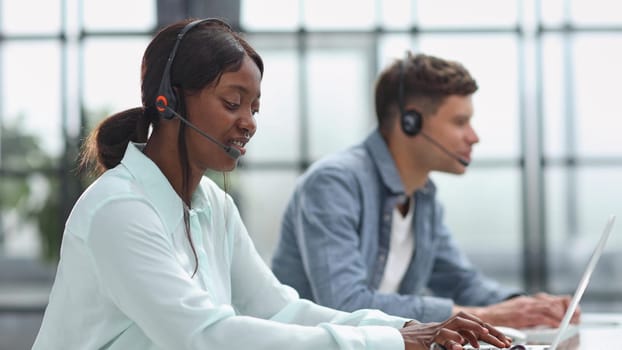 operators woman and man agent with headsets working in a call center.