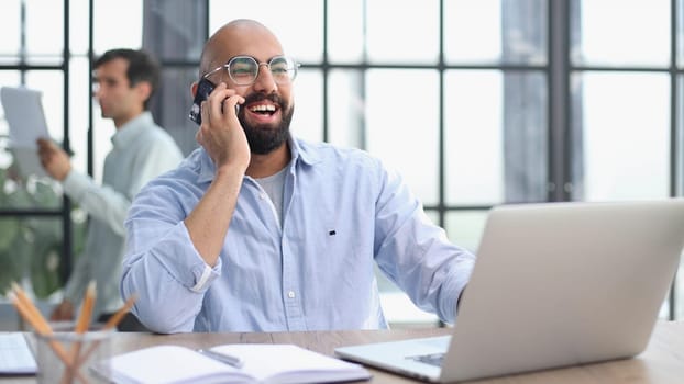 man working on the table with laptop in a new office