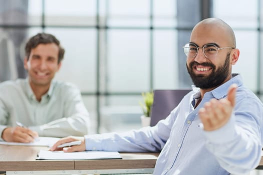 interview in the office. two young men smile.