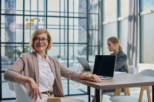 Young woman with computers at desk in office