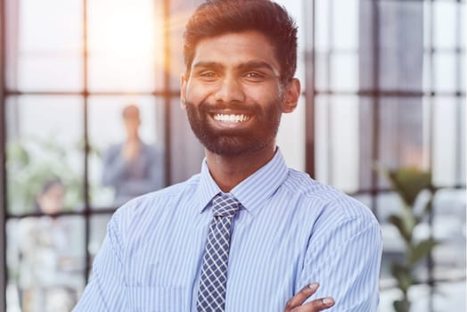 male investor beard looking at camera and smiling in modern office