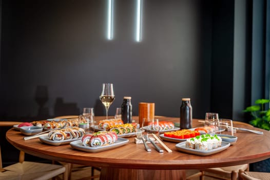 A set of sushi rolls on a table in a restaurant. High quality photo.