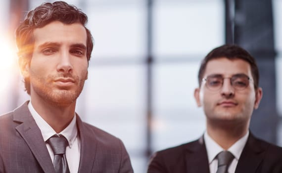 Two men business workers standing with arms crossed gesture at office