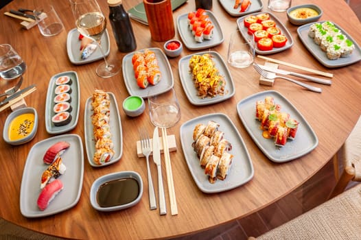 A set of sushi rolls on a table in a restaurant. High quality photo.