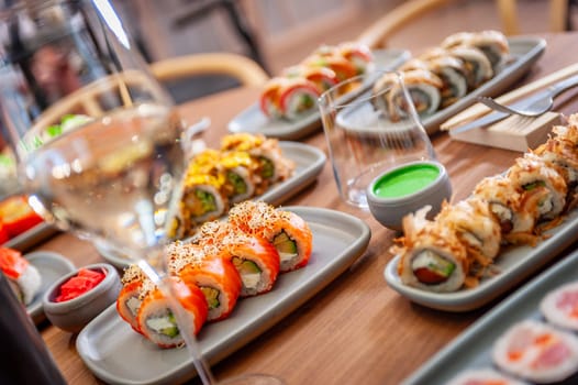 A set of sushi rolls on a table in a restaurant. High quality photo.