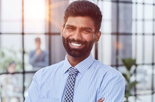 male investor beard looking at camera and smiling in modern office