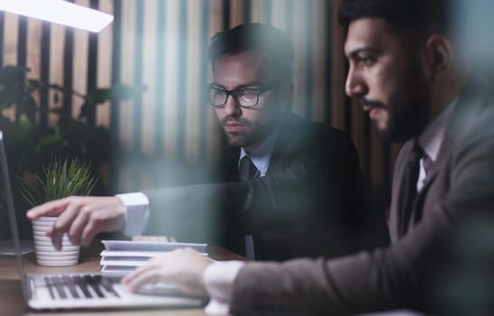 Young male in office working on desktop computer