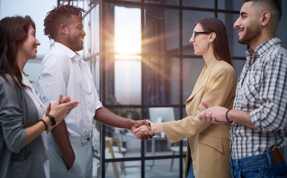 Businessman shaking hands with colleague after meeting in office