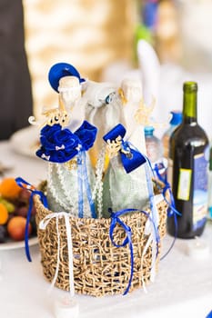 Two wedding champagne bottle on a basket