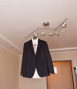 suit hanging on hangers. businessman or a groom suit