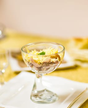 Salad with sticks of surimi, corn, eggs and mayonnaise on white table.