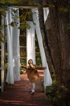 A girl in a mystical forest and flying curtains