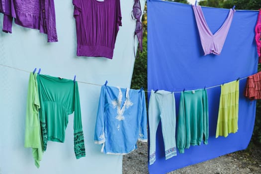 Colored clothes dry in the wind on a rope