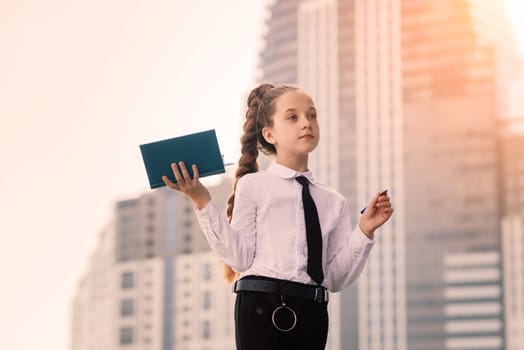 What is this book about. Literature lesson. Back to school. Modern education. Thinking little girl with notebook.