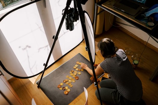 Photographer lays out the word from fruit chips on a dark background. High quality photo