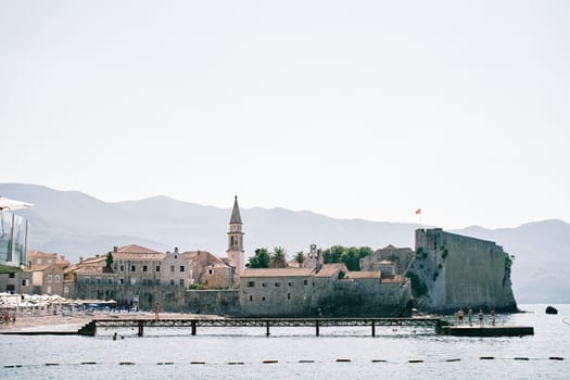 Long pier along the fortress walls of the citadel of the old town of Budva. Montenegro. High quality photo