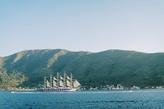 Luxury large sailboat sails on the sea along the mountainous coast. High quality photo