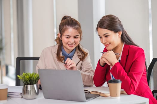 Two business women are discussing and exchanging knowledge on graphs and finance data..