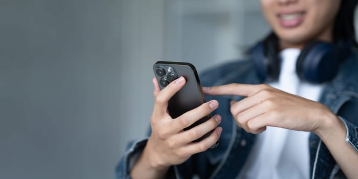 Close up of a man using mobile smart phone. Young Man finger touching on mobile phone screen.