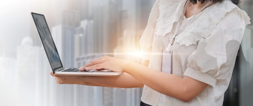 Double exposure image of business communication network technology concept business people using laptop device on modern cityscape background.