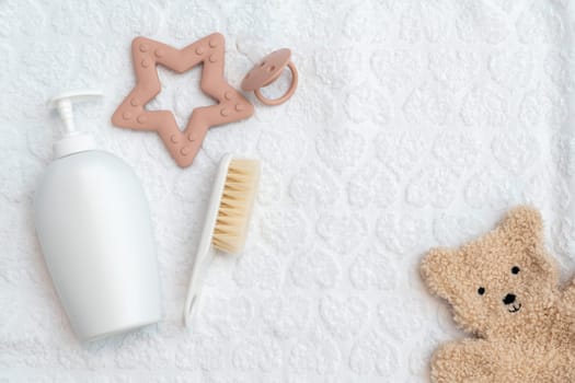 A collection of newborn accessories elegantly spread on a white background, top view, copy space