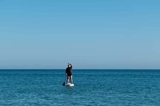 Caucasian man on paddle board in the sea.