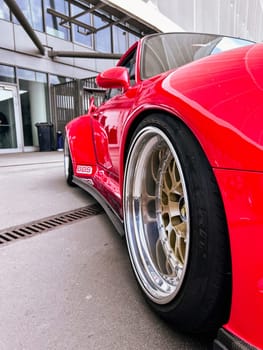 Fragment of a Red sport car, wheel BBS disk Closeup