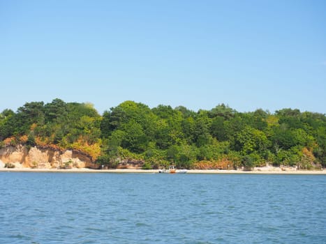 BrownSea Island the largest island in Poole Harbour seen from a boat