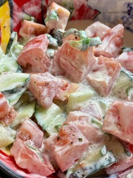 Summer salad, tomato cucumber salad with sour cream. High quality photo