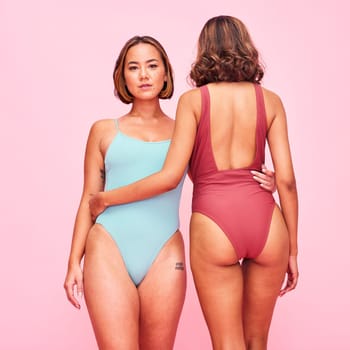 Bikini, fashion and portrait of friends with body positivity, beauty and style of women in swimsuit on pink background in studio. Swimming costume and face of Asian model with confidence and support.