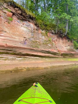 Kayaking on the river Gauja, exploring rocks . High quality photo