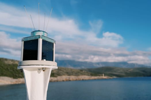 Marine solar powered LED lantern on a pole by the sea. High quality photo