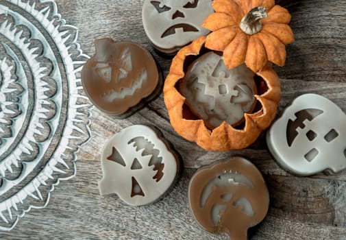 Delicious pumpkin ghost made with Agar powder in Halloween pumpkin. Tasty jelly in the shaped of cute ghost pumpkin. Celebrate with Halloween holiday, Pumpkin demon, Top view, Space for text, Selective focus.