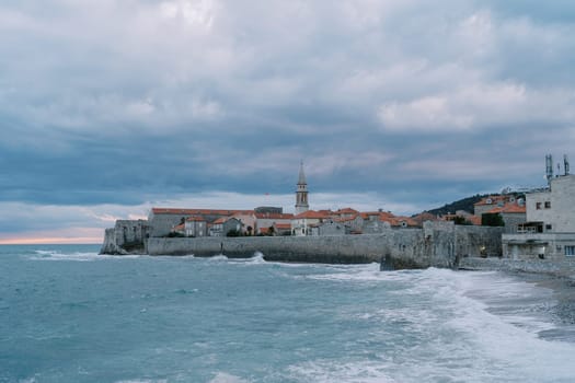Sea waves hit the stone wall of the old town of Budva. Montenegro. High quality photo