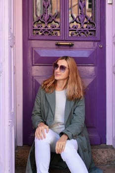 Young woman near purple door