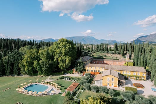 Swimming pool with sun loungers and parasols near the ancient Villa Cordevigo. Verona, Italy. High quality photo