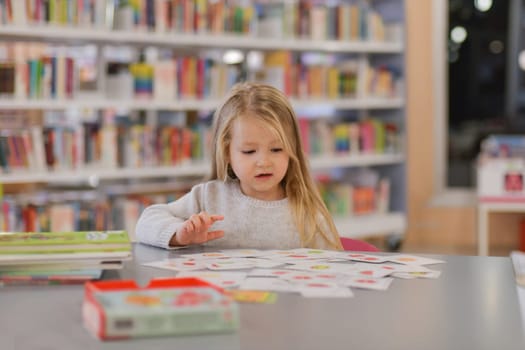 Girl plays games in a library