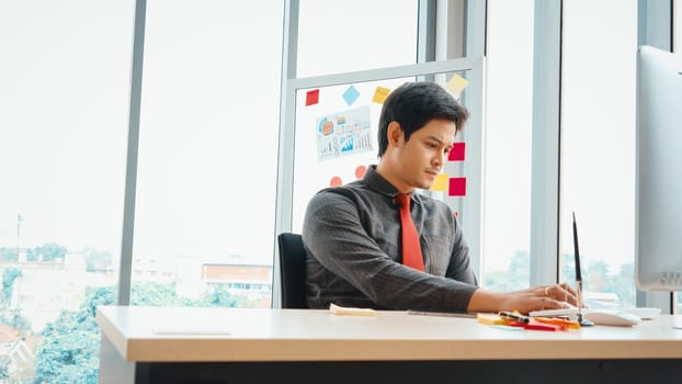 Business people working at table in modern office room while analyzing financial data report . Jivy