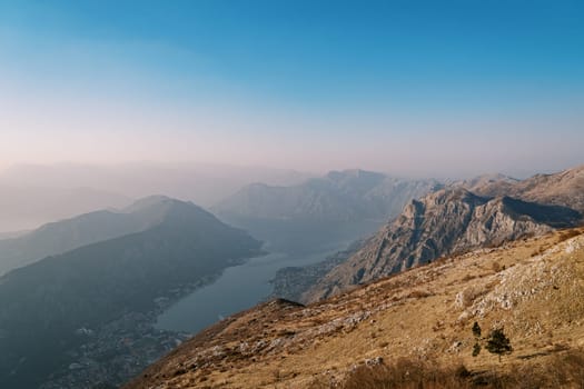 View from the mountain to the valley of the Bay of Kotor and mountains in the fog. High quality photo