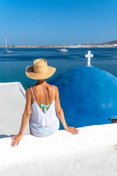 Woman sitting at Monastery of St. John's of Deti in Paros, Greece