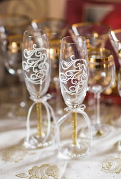 Close-up of wedding decorated champagne glasses on the table.