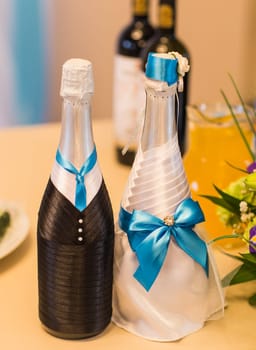 Decorated wedding bottle of champagne. Wedding reception