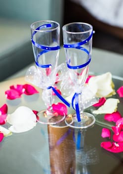 Close-up of wedding decorated champagne glasses on the table.