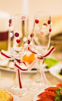 Close-up of wedding decorated champagne glasses on the table.