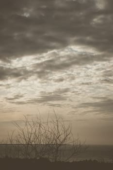 Abstract background sky Dawn Sunset Contrast dark shadow bright cloud sun orange silhouette above the mountains near the sea.