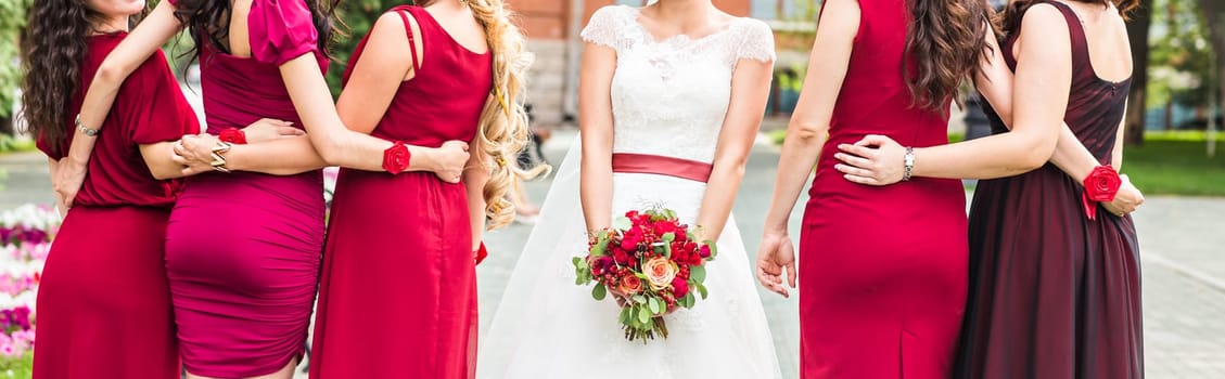 Bride and bridesmaids hand with beautiful flowers.