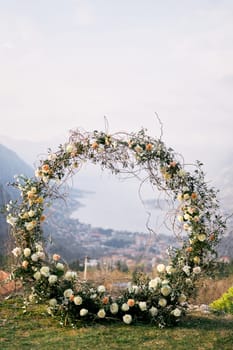 Round wedding arch stands on a mountain overlooking the sea valley. High quality photo